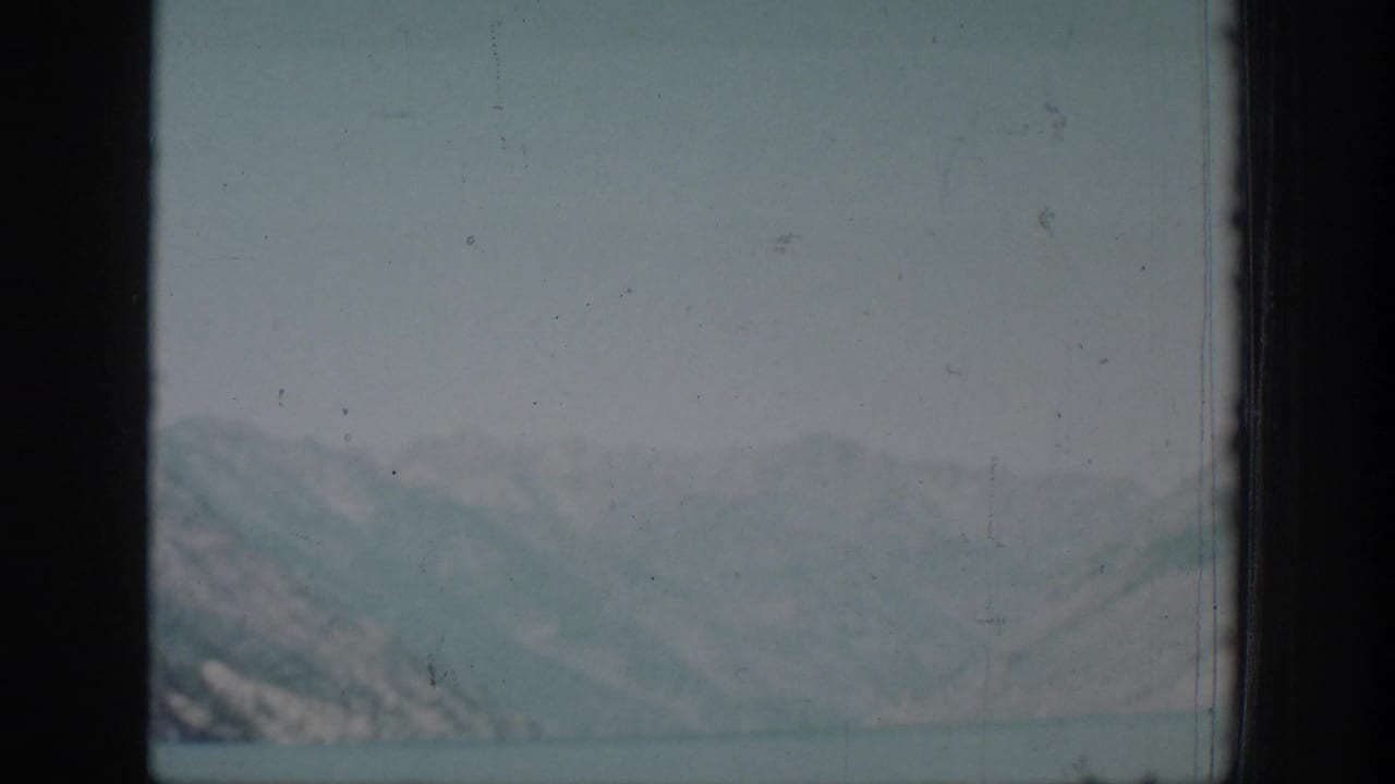 A hazy lake view with distant mountains appears in the Chelan home-movie sequence.