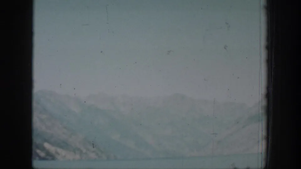 A hazy lake view with distant mountains appears in the Chelan home-movie sequence.