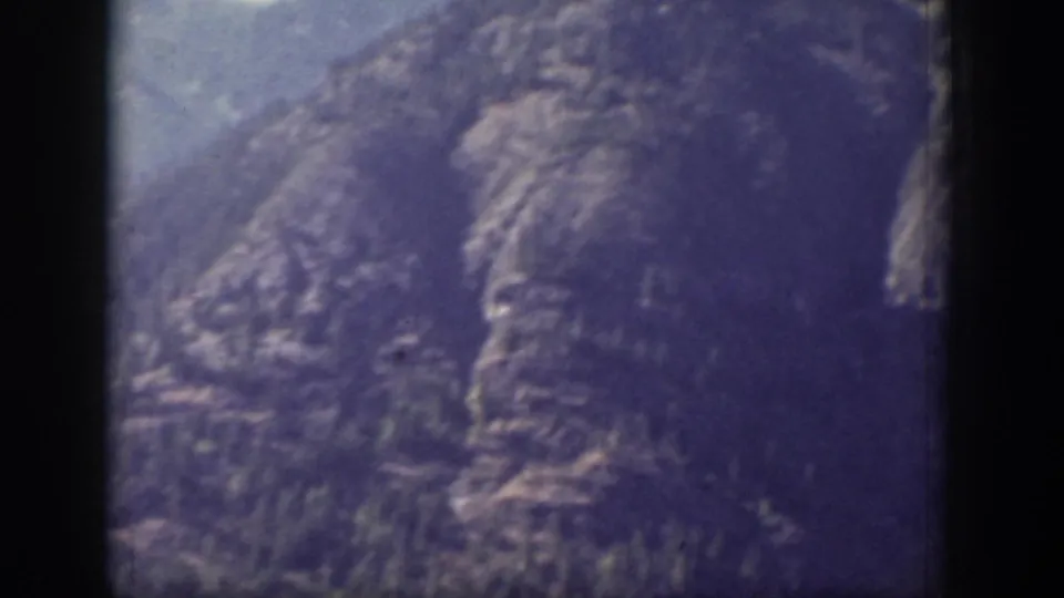 1939 Chelan, Washington home-movie frame showing a close view of rugged mountain slopes beneath pale blue sky.