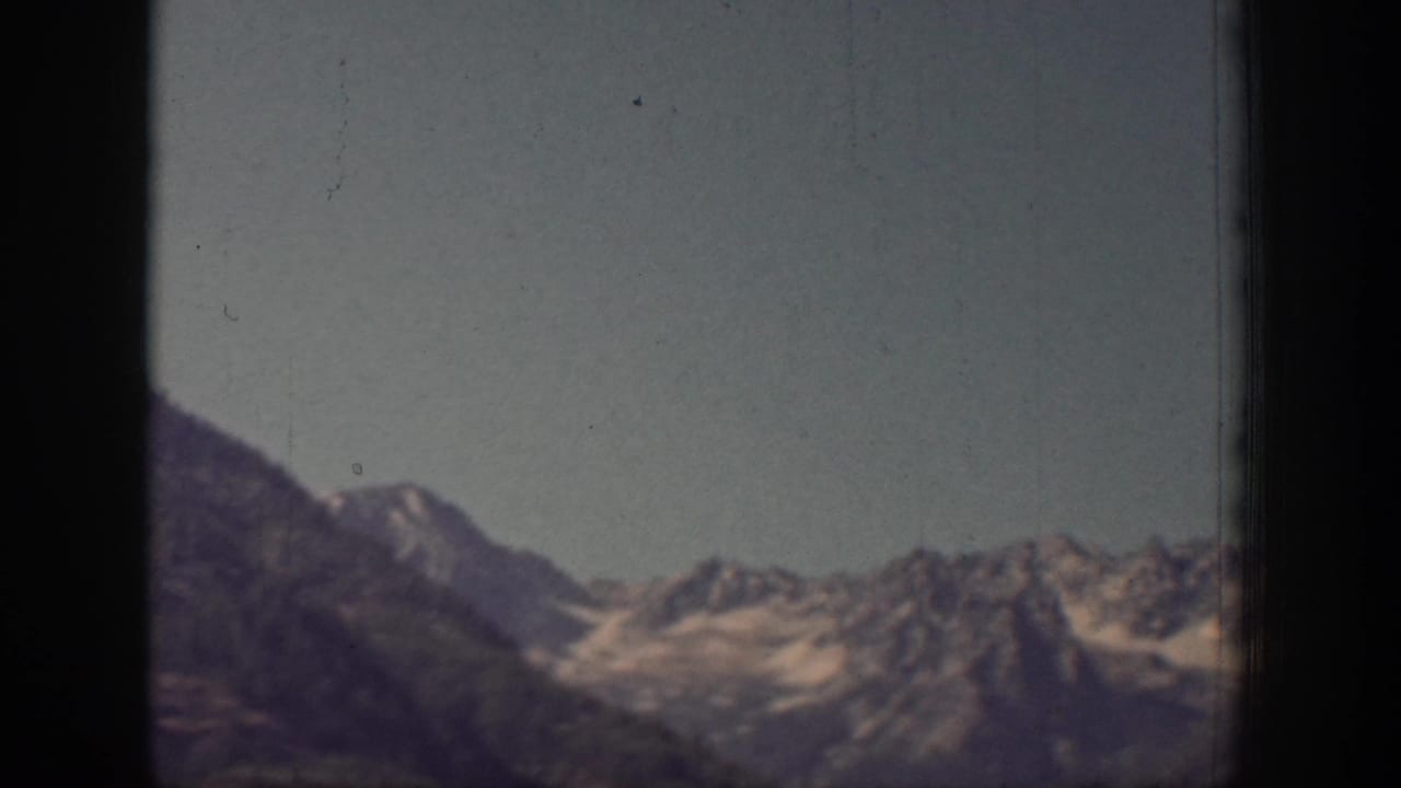 A wide view of snow-dusted mountain ridges and pale sky closes the brief Chelan, Washington scenery shot.