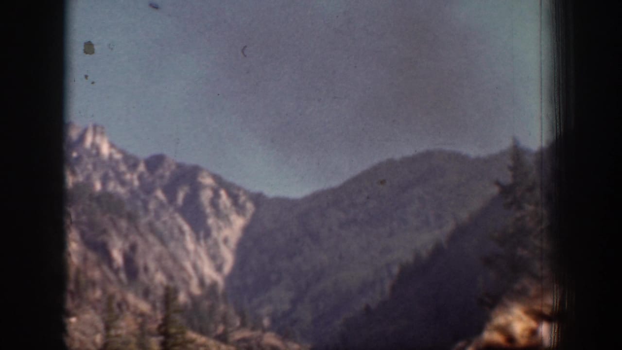 Chelan-area mountain ridges appear in a soft, handheld 1939 8mm landscape view.