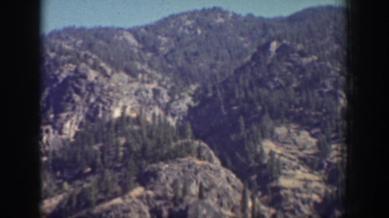 Chelan, Washington 8mm frame showing rugged forested hills and rocky ridges above a mountain lake.