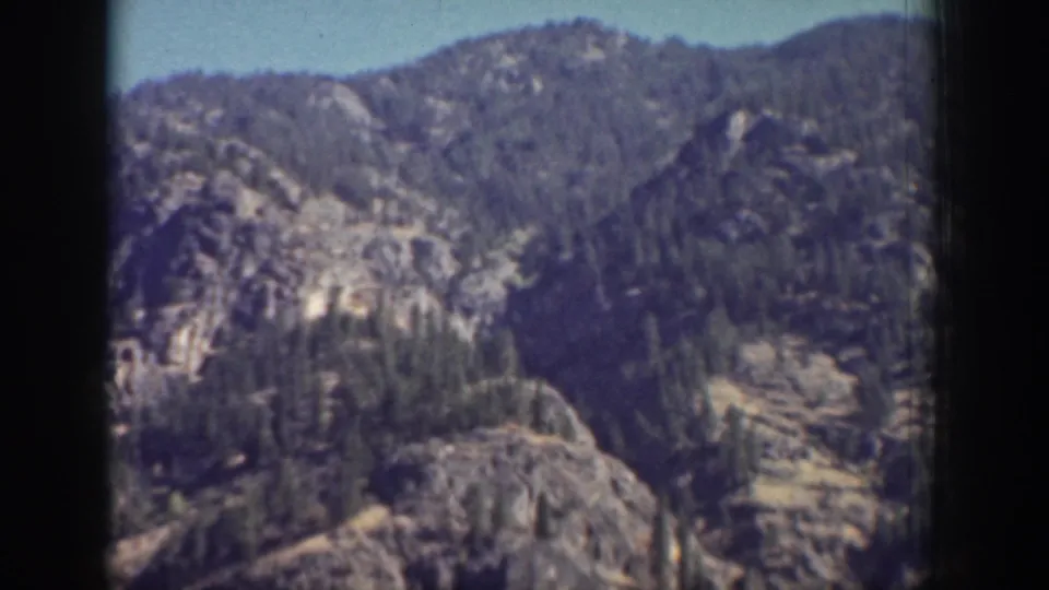 Chelan, Washington 8mm frame showing rugged forested hills and rocky ridges above a mountain lake.