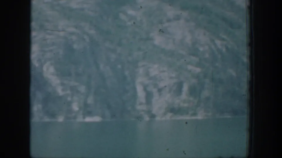 A soft 8mm view shows water in the foreground and a hazy mountainous shoreline, consistent with the Chelan travel setting.