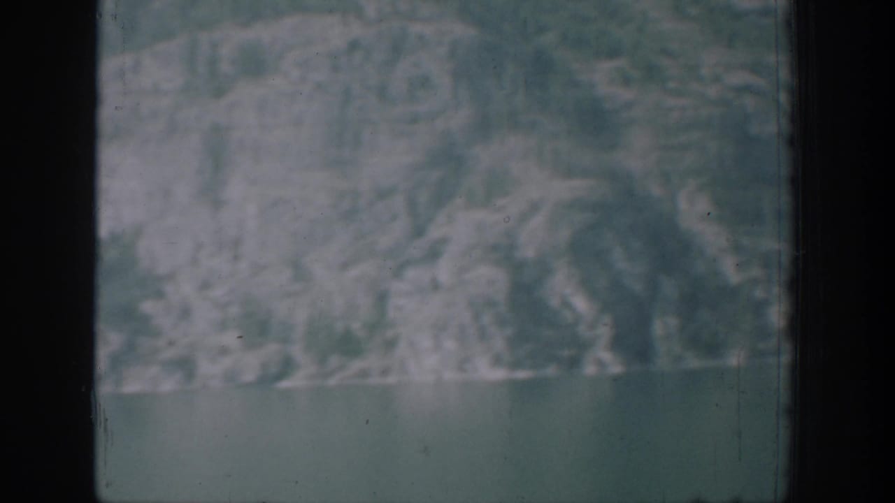 A distant mountain-and-water view closes the Chelan 8mm clip, with soft exposure and visible frame edges.
