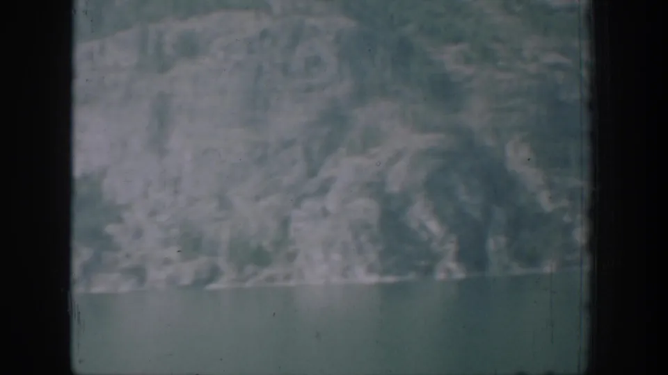 A distant mountain-and-water view closes the Chelan 8mm clip, with soft exposure and visible frame edges.
