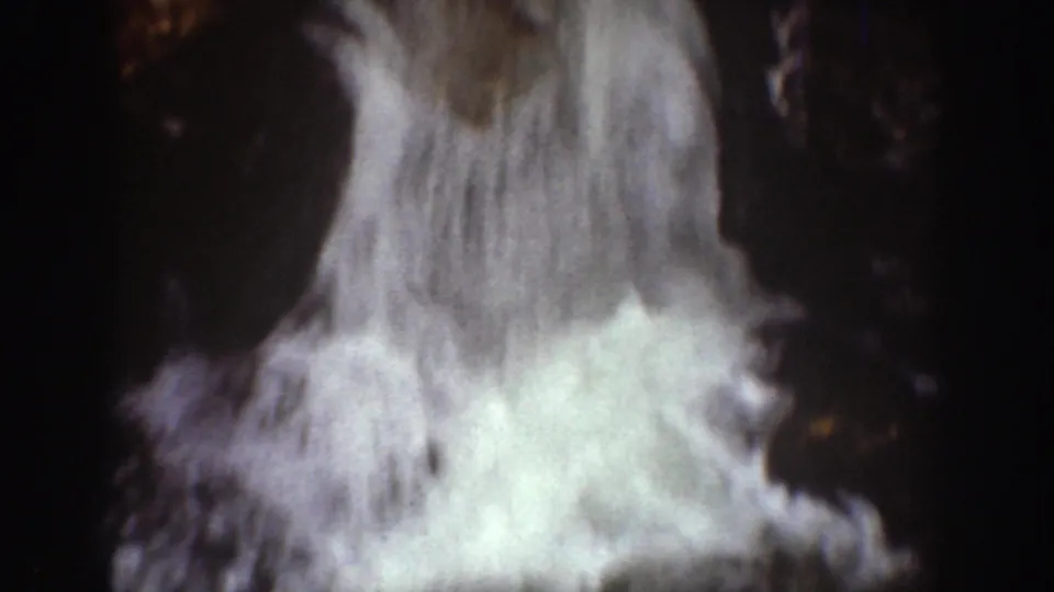 1939 Chelan-area 8mm frame showing bright waterfall flow spilling over dark rocky terrain.