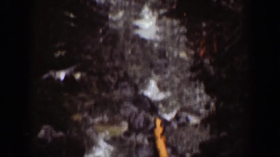 1939 Chelan, Washington 8mm frame showing a darker lower view of wet rocks, falling water, and shadowed gorge terrain.