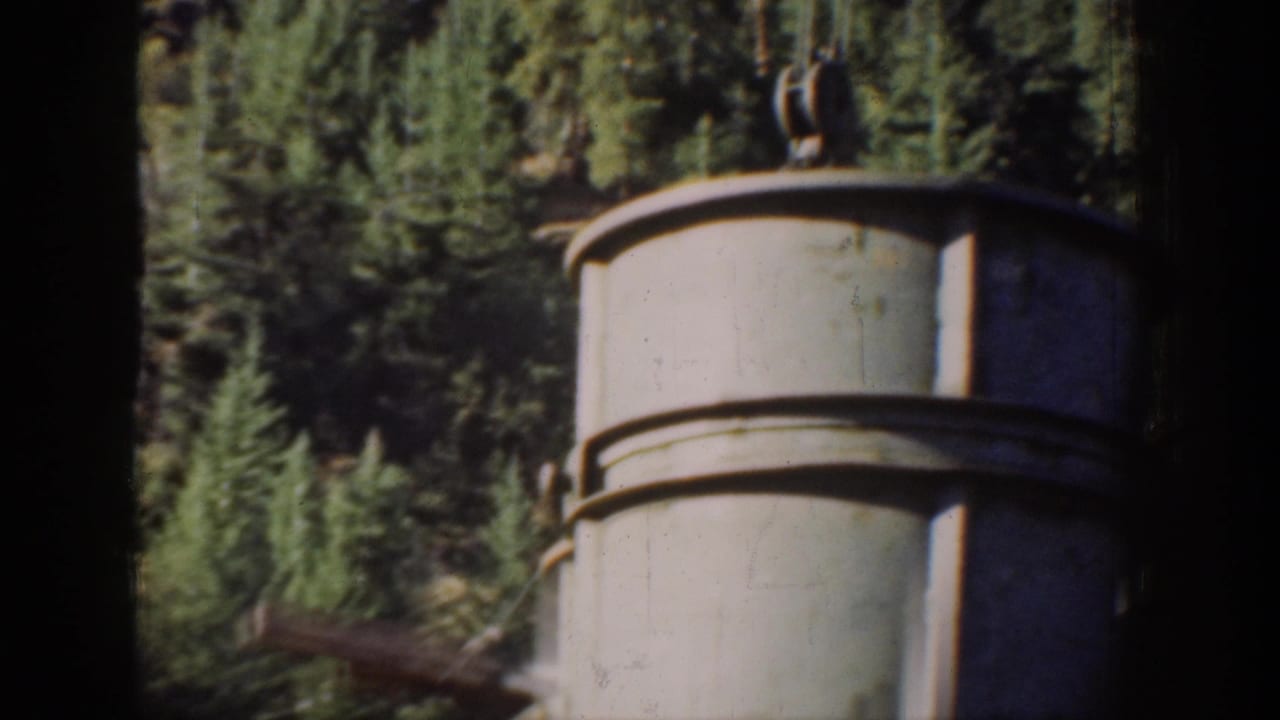 Heavy cylindrical load lifted by steel rigging cables at a Washington State industrial site, circa 1939, 8mm home movie