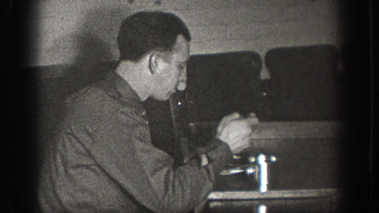 Man eating from a plate at an indoor table with a chrome condiment item alongside, possibly a bar or diner in Chelan Washington, circa 1939, 8mm film.