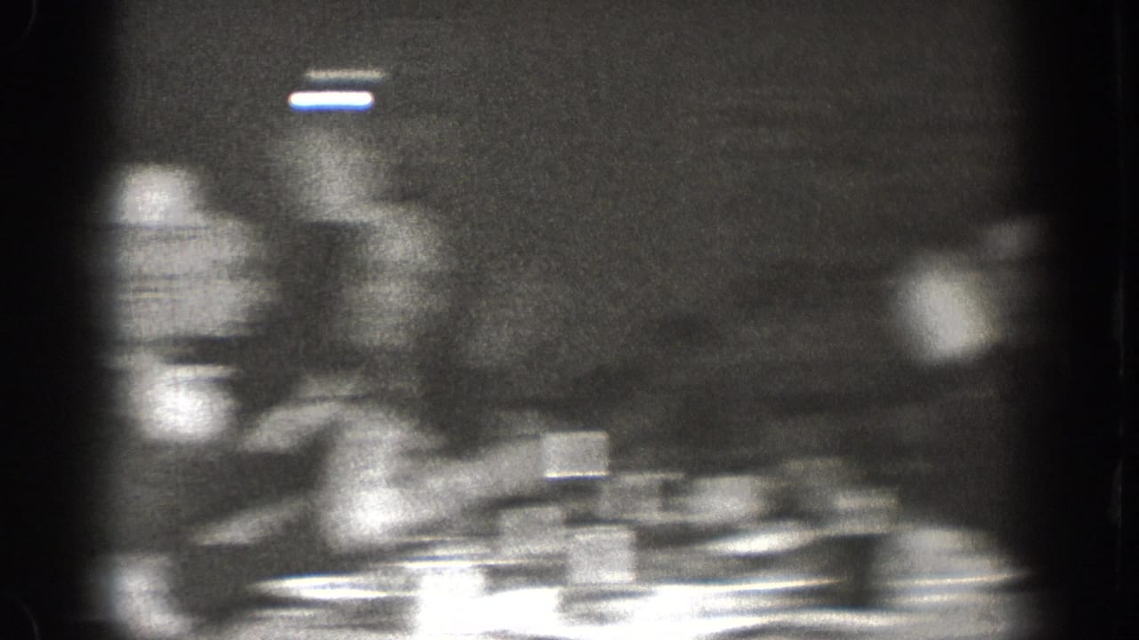 Final frame of Chelan, Washington 1939 8mm footage rendered largely indistinct by motion blur; dining table and cups partially visible.