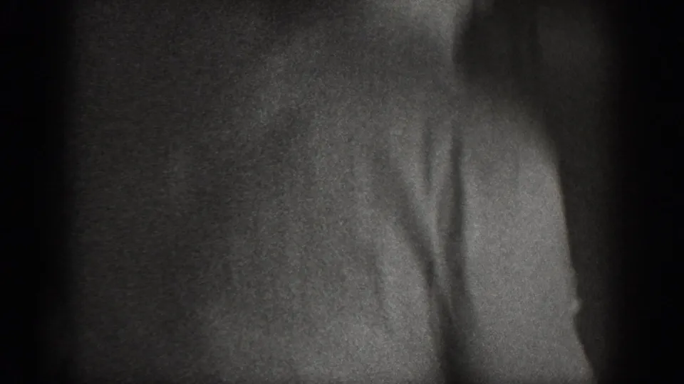 Heavily underexposed 8mm frame showing only a faint partial silhouette at the right edge; minimal visible content, circa 1939.