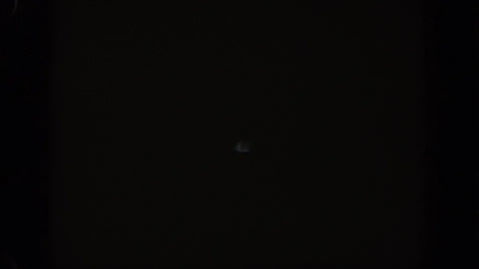 Deep inside a mountain road tunnel, circa 1961; 8mm exposure collapses to near-black with a faint ambient glow at center.