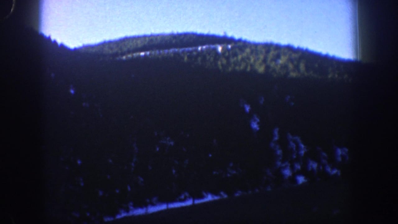 Mountain valley and evergreen-forested slopes filmed on 8mm, consistent with the Aspen, Colorado area circa 1961.