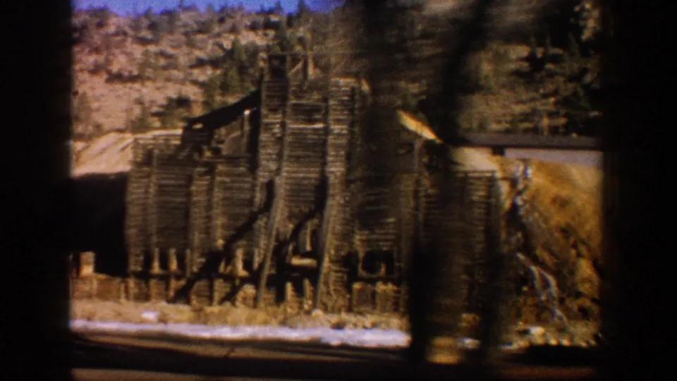 Close-up of aged stacked timber structural elements, possibly a headframe or ore-sorting structure, at a Colorado mining site circa 1961.