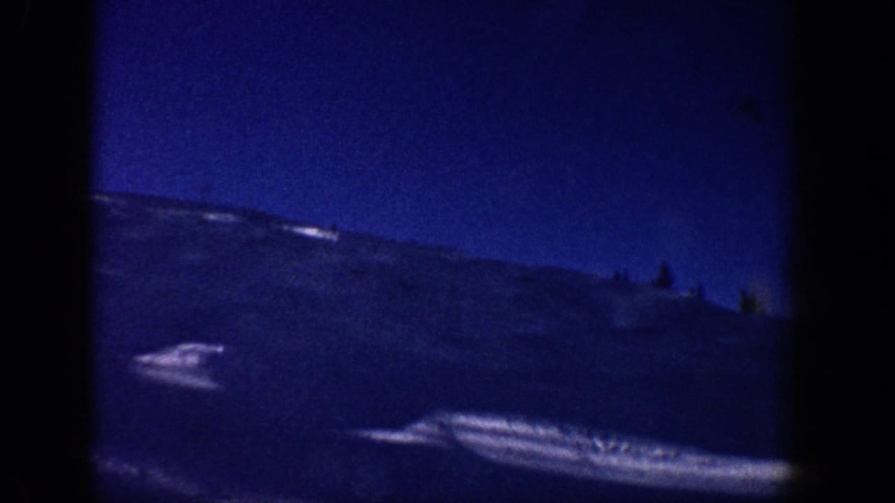 8mm panoramic shot of broad alpine slope with deep blue-shifted sky, likely Aspen-area mountains, circa 1961.