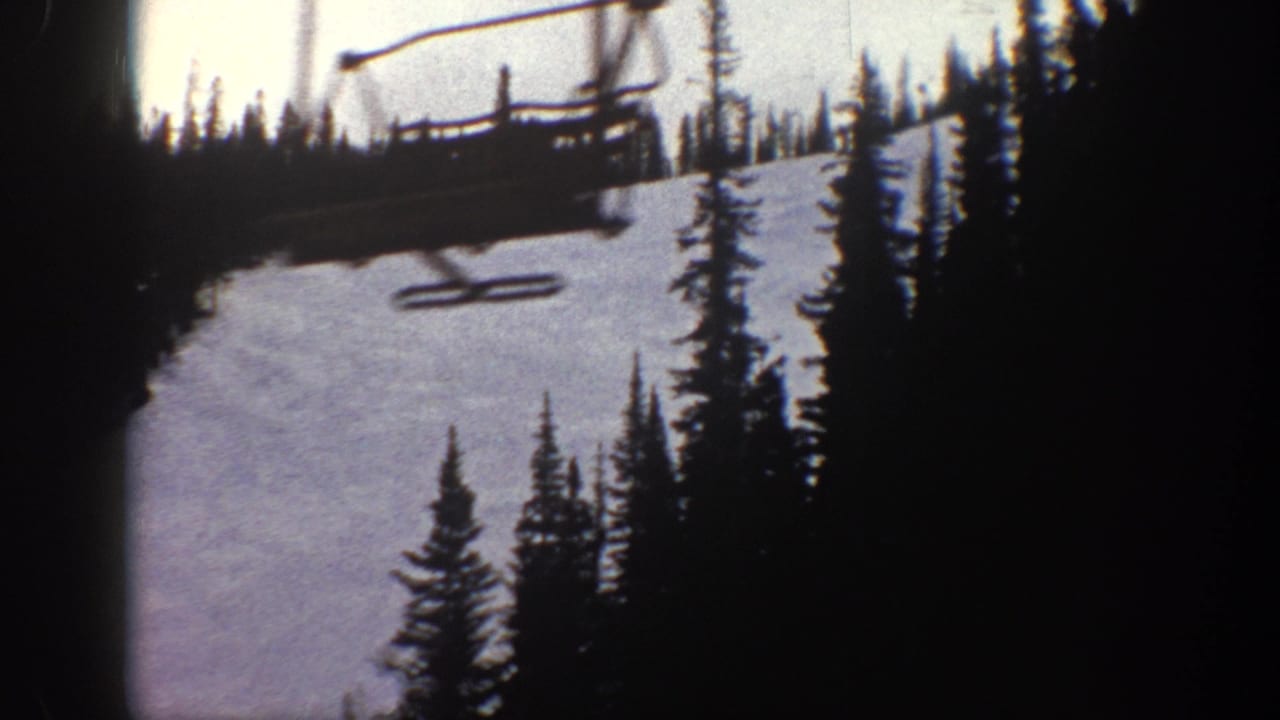 8mm home movie close-up of a ski chairlift above a snow-covered slope, likely Aspen Colorado circa 1961, with purple-tinted film stock and gate vignette.