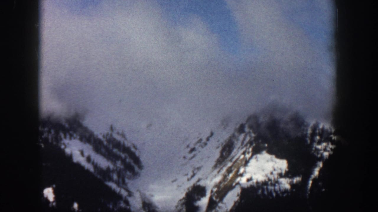 Snow-covered mountain peaks, possibly Aspen area, Colorado, circa 1961, on 8mm color film with visible grain and frame borders.