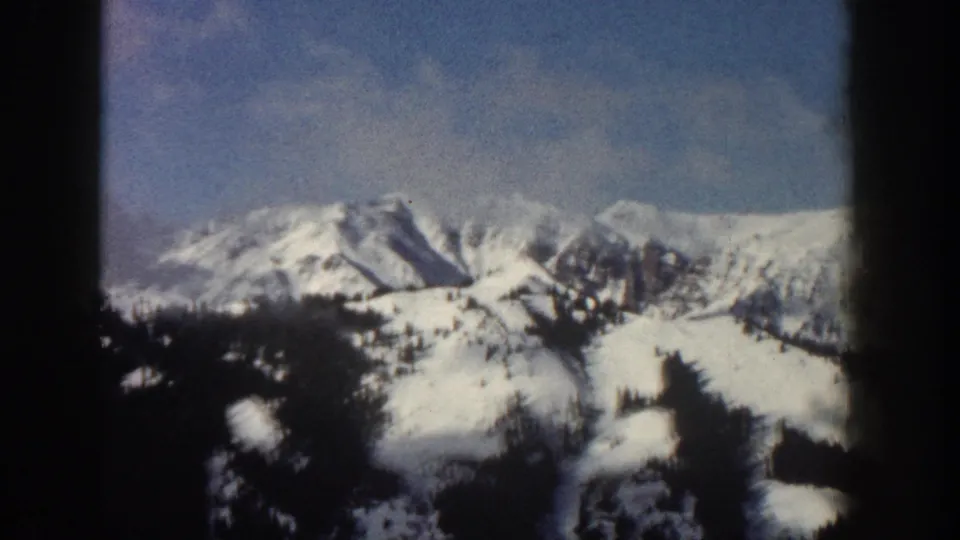 Broader winter mountain panorama, possibly Aspen area, Colorado, circa 1961; snow-covered slopes and ridgeline visible under blue sky.