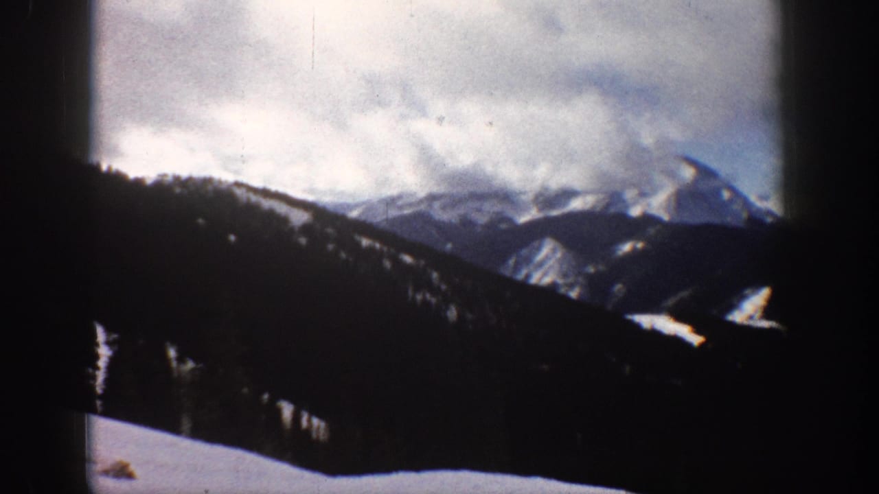 Winter mountain landscape, possibly Aspen Colorado area, circa 1961, shot on 8mm color film with characteristic projector frame vignetting