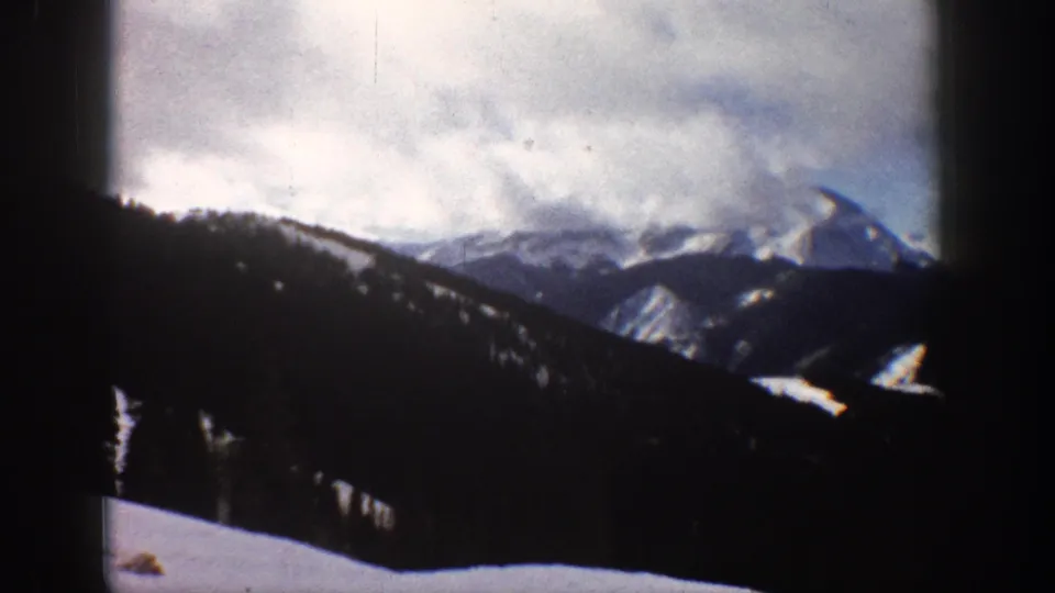 Winter mountain landscape, possibly Aspen Colorado area, circa 1961, shot on 8mm color film with characteristic projector frame vignetting