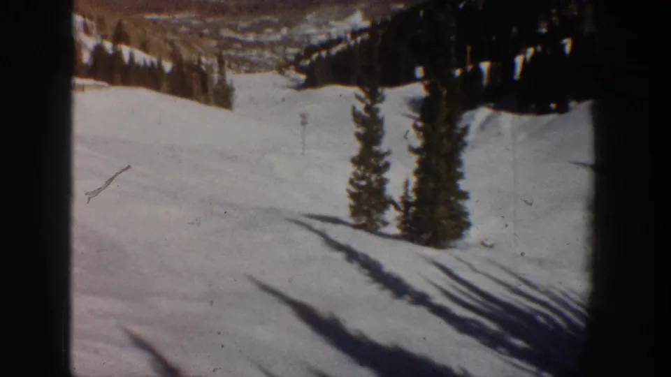 8mm color film frame showing a snowy mountain slope opening to a distant valley below, consistent with the Aspen Colorado area, circa 1961.