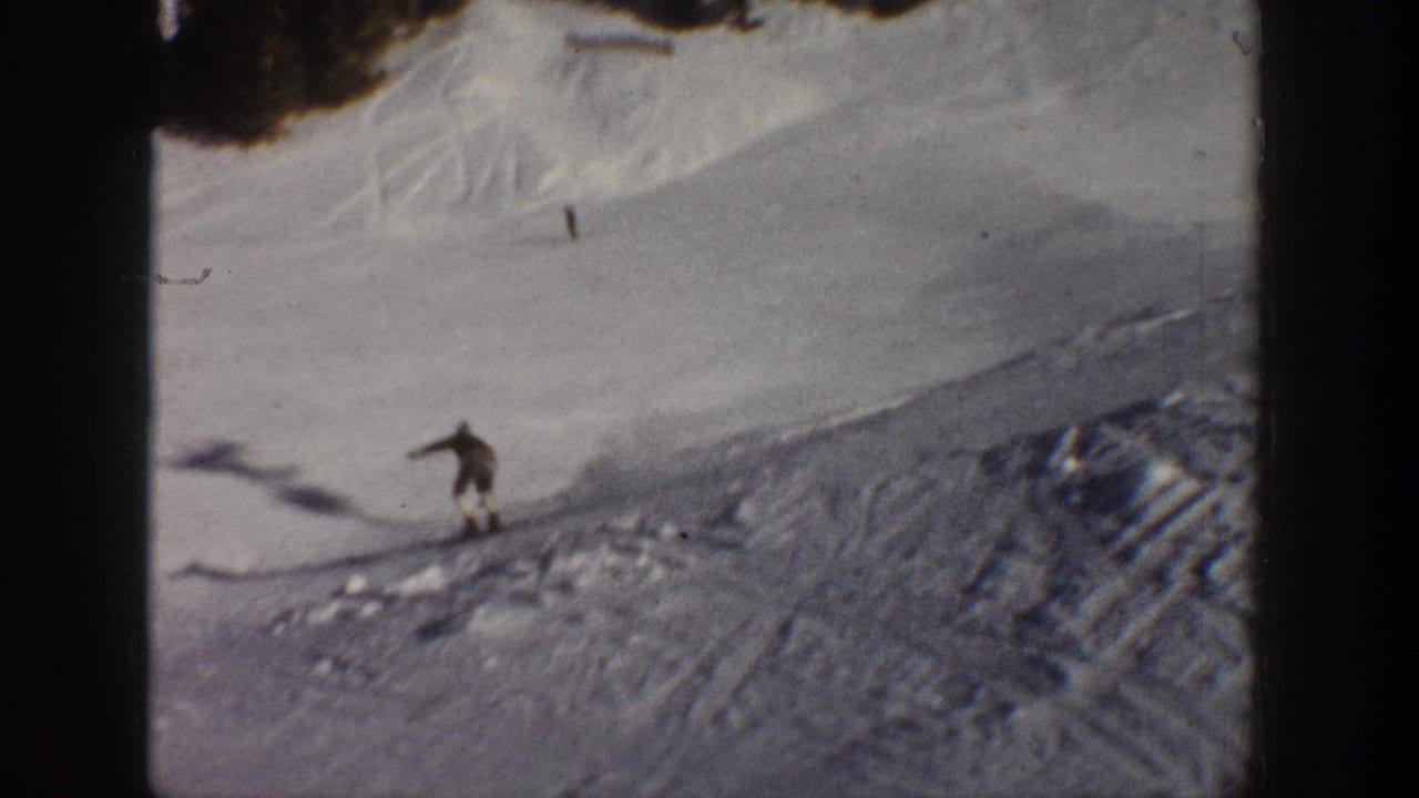 A distant skier descends a snowy Aspen slope in 1961, with ski tracks, tree shadows, and rounded 8mm frame edges visible.