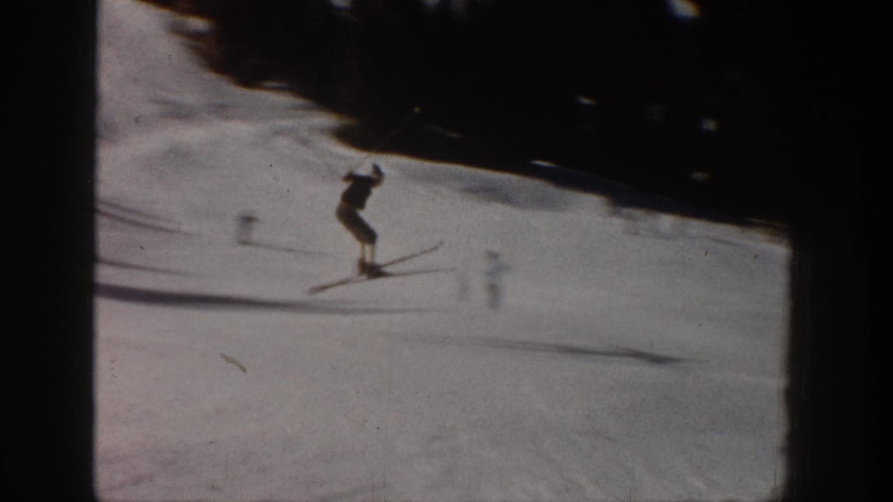 1961 Aspen ski footage frame with a skier briefly airborne or unweighted on the snowy slope.