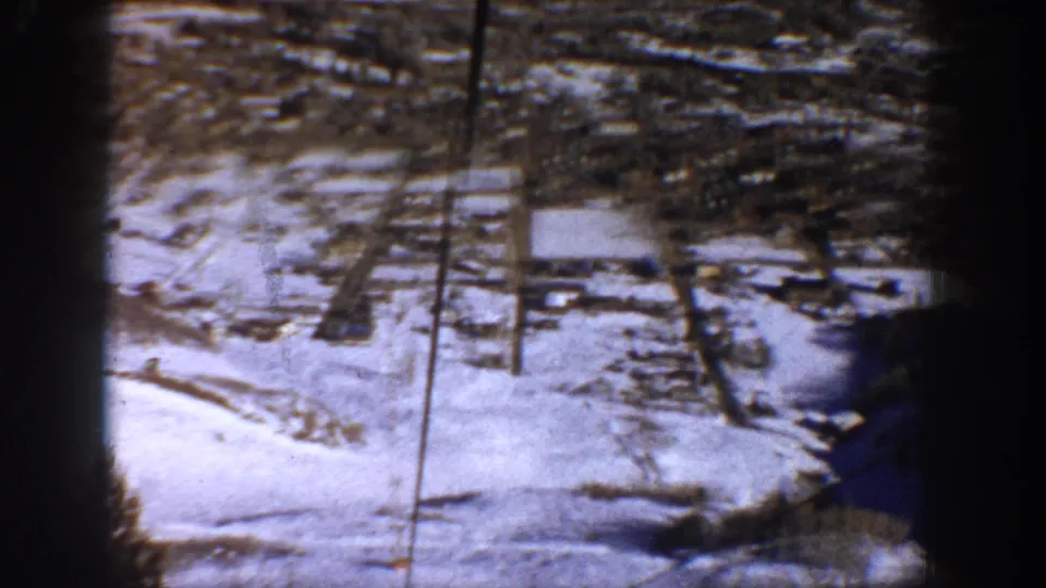 A shaky aerial view appears to show a snow-covered town grid in Aspen, Colorado, based on the supplied location metadata.