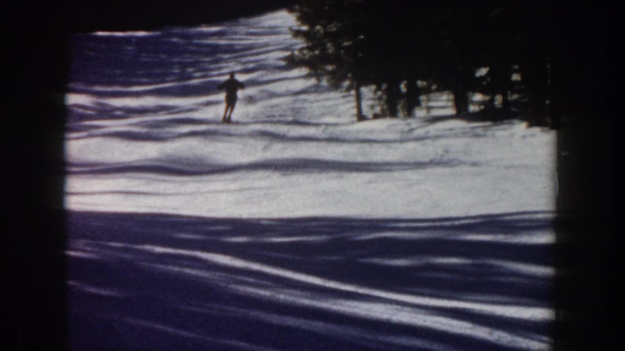 A distant skier descends a snowy Aspen slope in 1961, with evergreen trees and blue shadows framing the run.