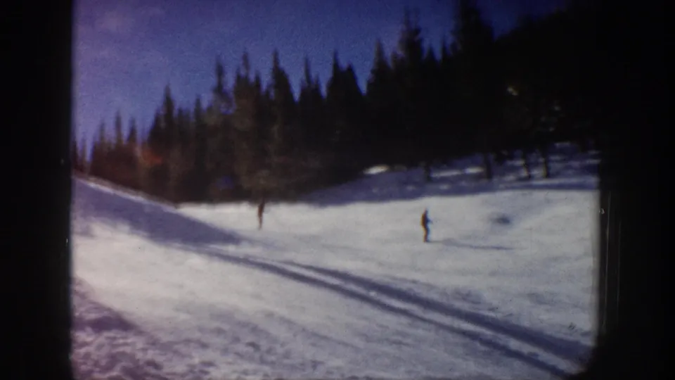 A distant skier moves across a snowy Aspen slope in this soft 1961 8mm home-movie frame.