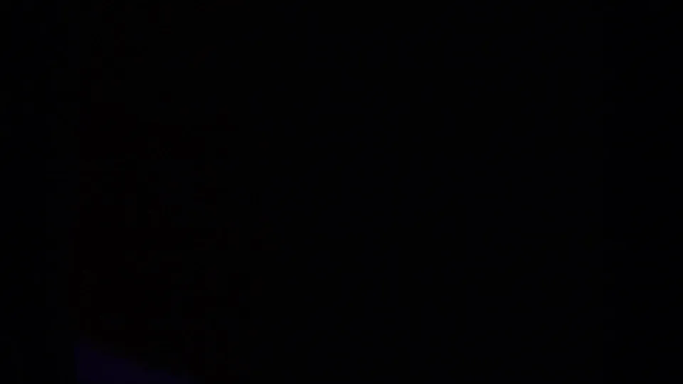 Underexposed 8mm frame section with a mostly black field, likely between or beside visible ski footage on the contact sheet.