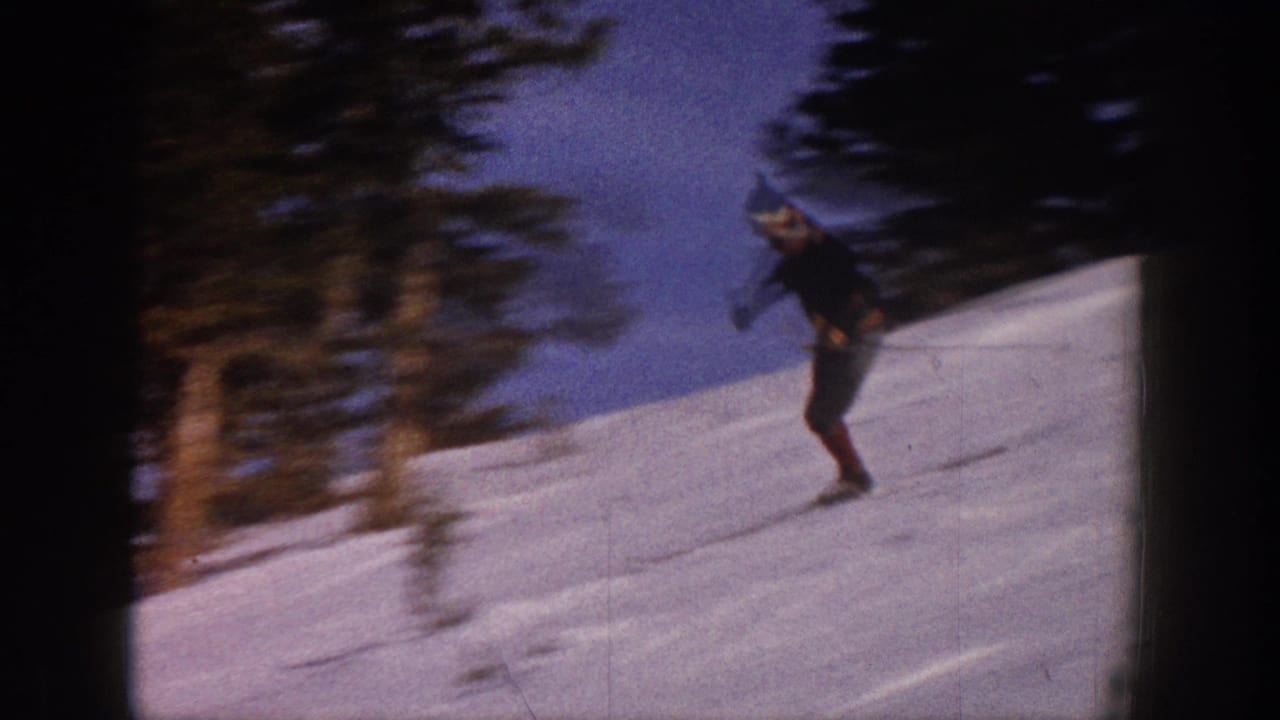 A man skis across a snowy Aspen, Colorado slope in 1961, framed by trees and dark 8mm contact-sheet borders.