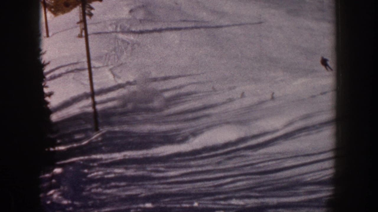 Snowy ski slope with a utility pole, pine edge, and small skier figures.