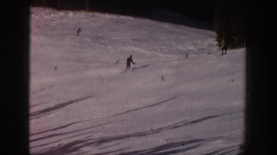 Distant skier on an Aspen, Colorado slope in 1961, seen through grainy 8mm home-movie footage.