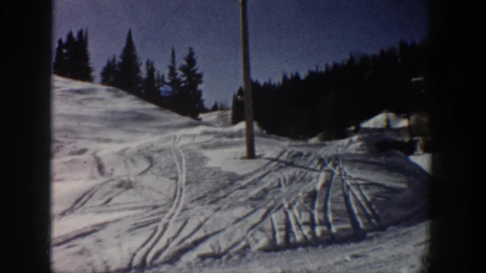 The final frame shows the tracked Aspen snow slope after the skier has moved out of view, with pine trees, blue sky, and a pole visible.