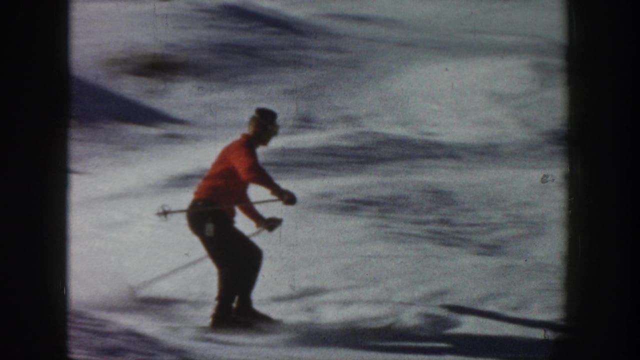 In 1961 Aspen, Colorado footage, an adult skier in a red sweater practices on a bright snowy slope with ski poles.