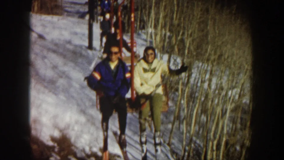 The skiers approach on the chairlift in the Aspen footage, with the woman gesturing and winter trees filling the background.