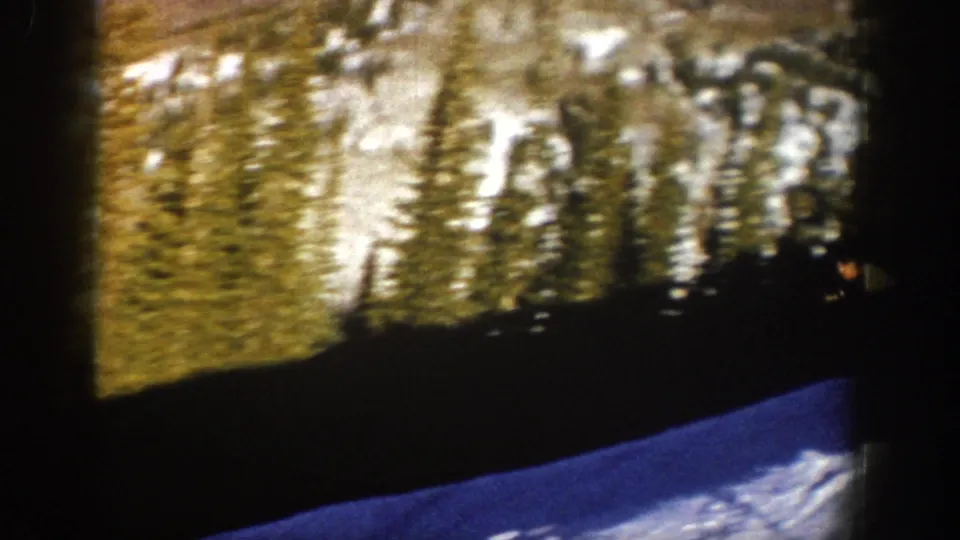 Aspen winter landscape on 8mm film, with snow, trees, and dark frame edges from the scan.
