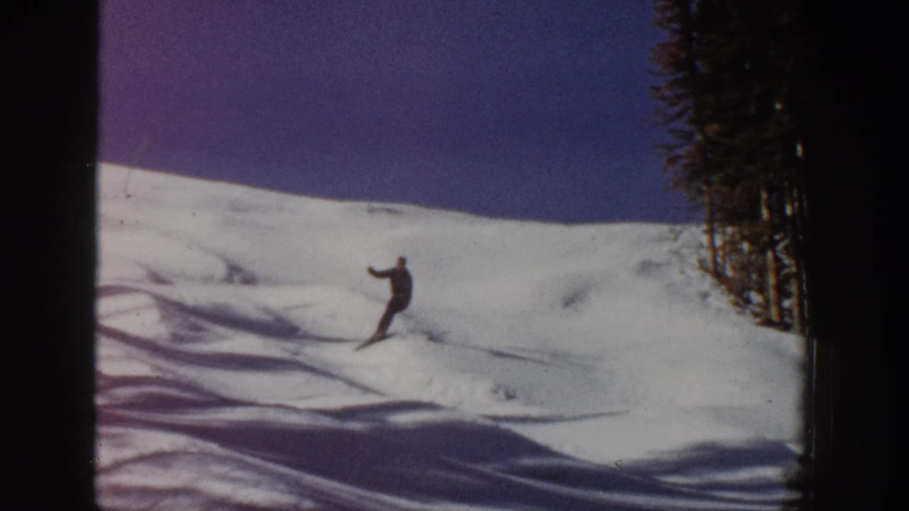 A lone skier in dark clothing descends an Aspen snowfield in this 1961 home-movie frame.