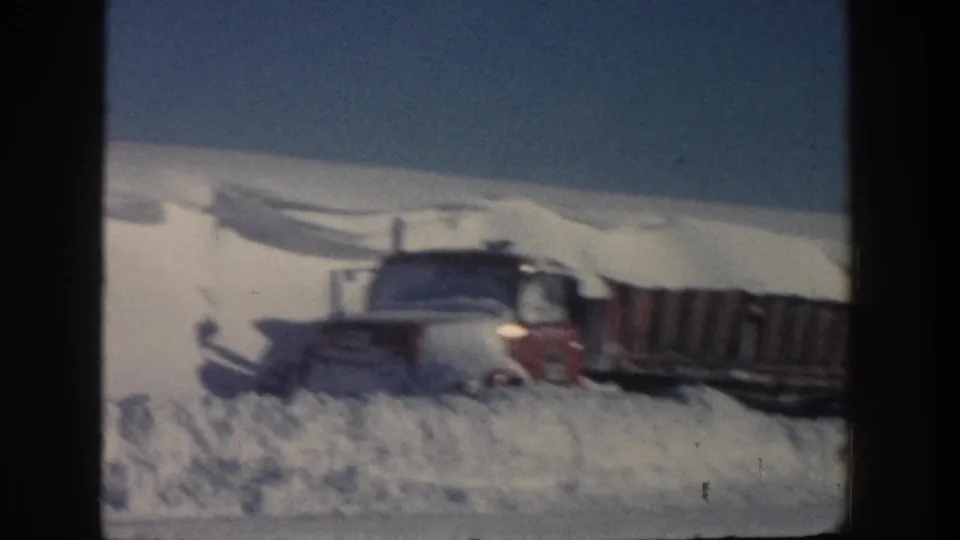 Side view of the snowbound truck and trailer on a rural winter road in Aspen, Colorado, supported by the 1961 clip metadata.