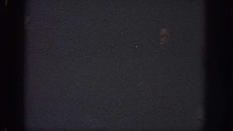 Low-light 1951 Atlanta pool frame with a faint swimmer visible against dark blue-black water.