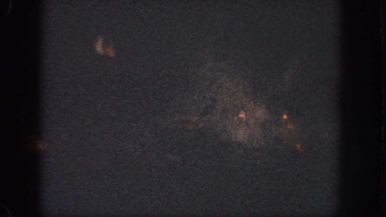 Low-light 1951 Atlanta swimming-pool frame with a faint swimmer or splash pattern near the lower right.