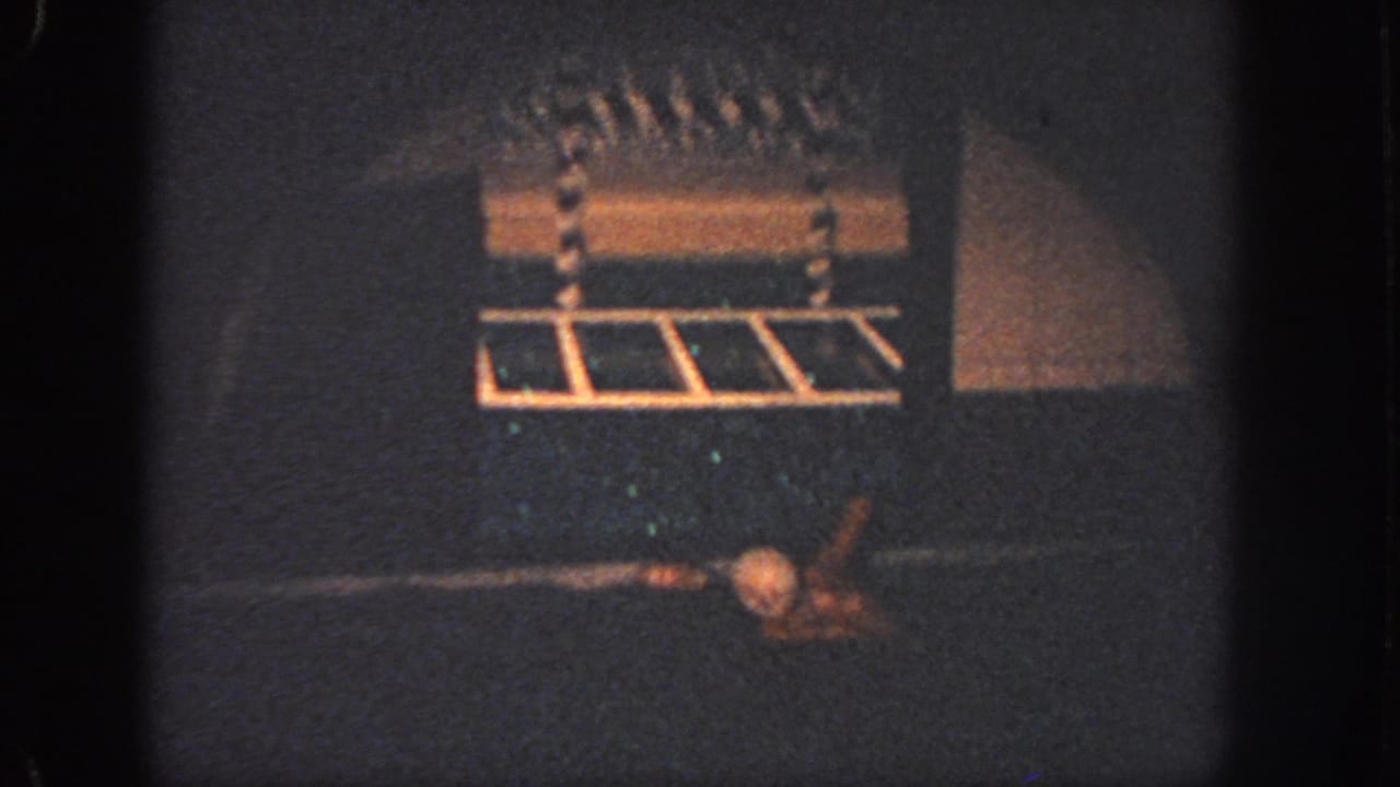 Possible poolside starting block or platform appears above dark water in the 1951 Atlanta 8mm swim footage.