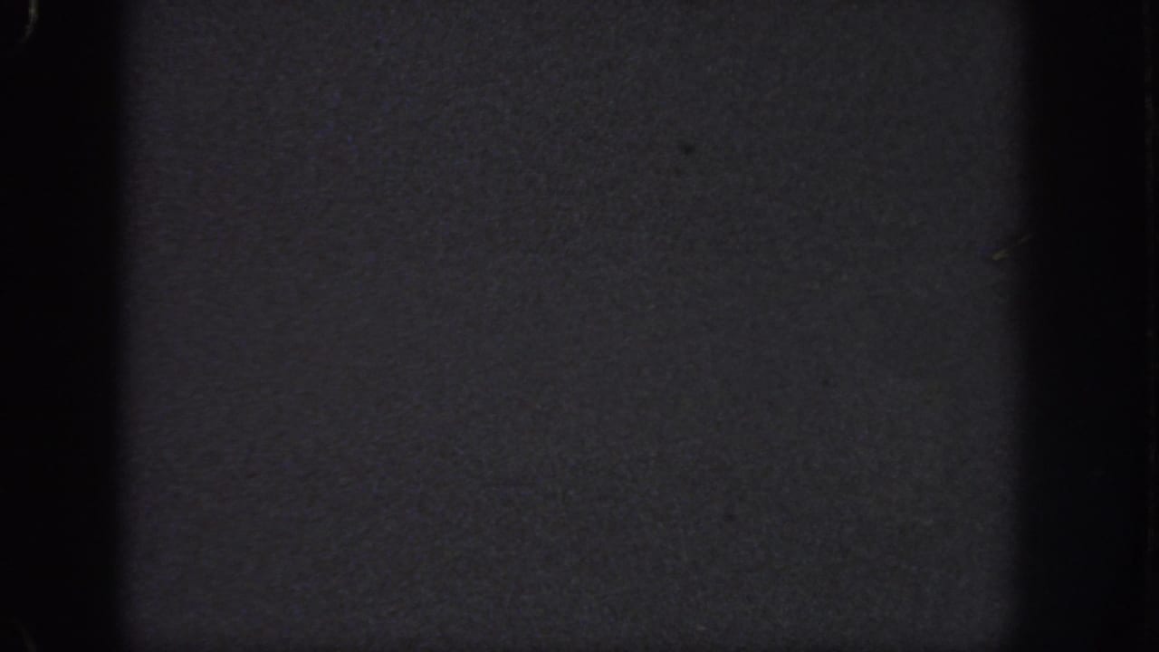 Dark 1951 8mm home-movie frame from Atlanta metadata, showing grain, edge wear, and little identifiable subject matter.