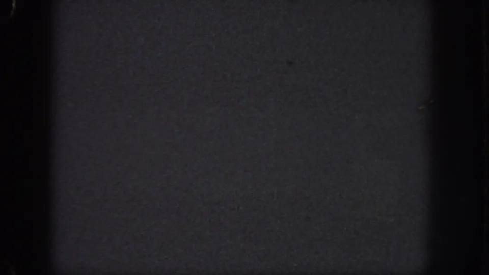Dark 1951 8mm home-movie frame from Atlanta metadata, showing grain, edge wear, and little identifiable subject matter.