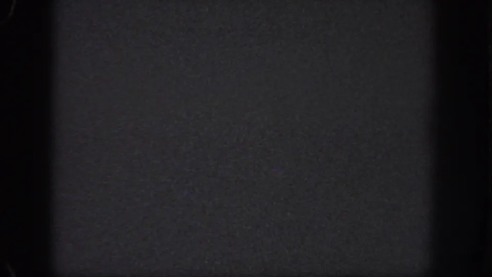 Dark 1951 Atlanta 8mm frame with dense grain, worn edges, and no identifiable people, places, or objects.