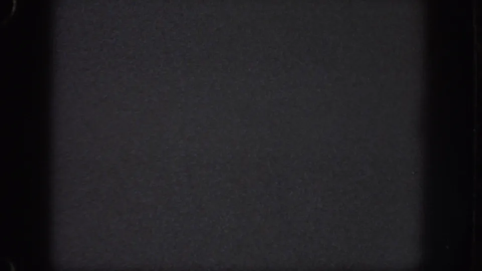 Atlanta 1951 8mm frame showing a nearly black night view with visible gate edges and only faint surface detail.