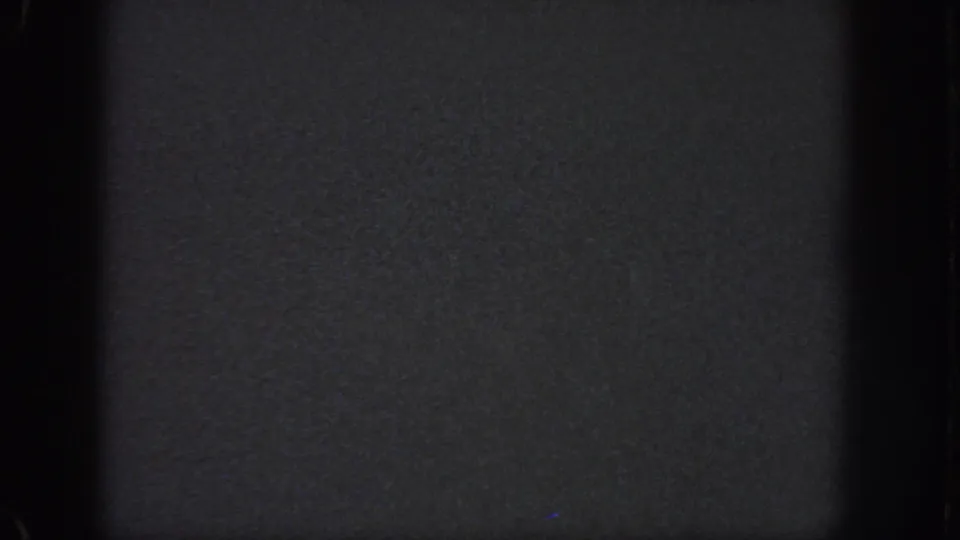 Atlanta 1951 8mm night frame with soft grain, black film borders, and indistinct dark surface detail.
