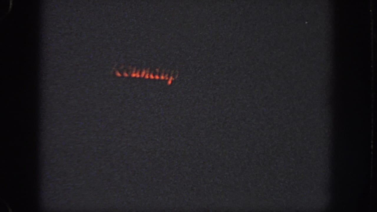 1951 Atlanta 8mm frame with a short red-orange light trail crossing a dark nighttime field.